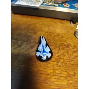 Hand blown black, blue and white floral design pendent.